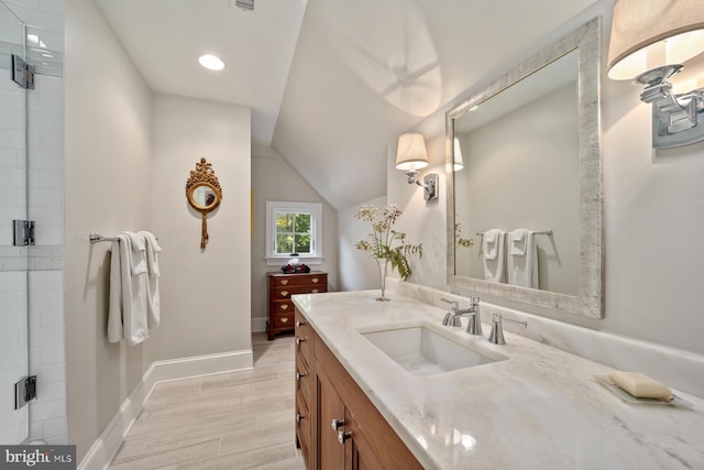 full bathroom with vanity, a shower stall, baseboards, vaulted ceiling, and recessed lighting
