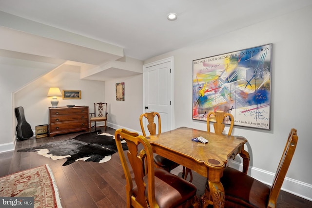 dining room with baseboards, wood finished floors, and recessed lighting