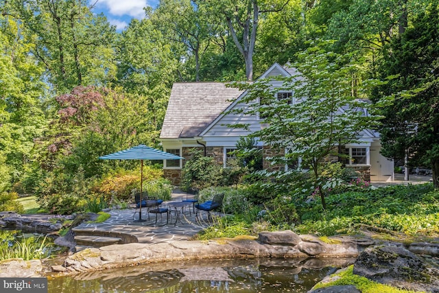 view of home's community with a patio area