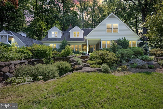 view of front of home featuring a front yard and a chimney