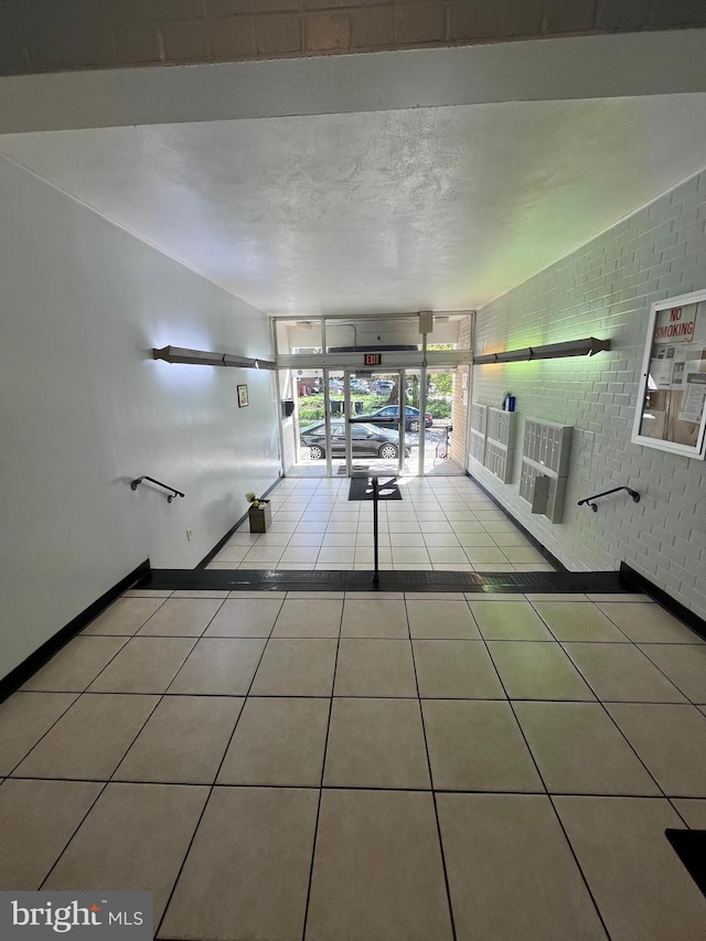 1920 Naylor Rd SE Unit 106, Washington, DC 20020 - hallway with tile patterned floors, baseboards, and brick wall