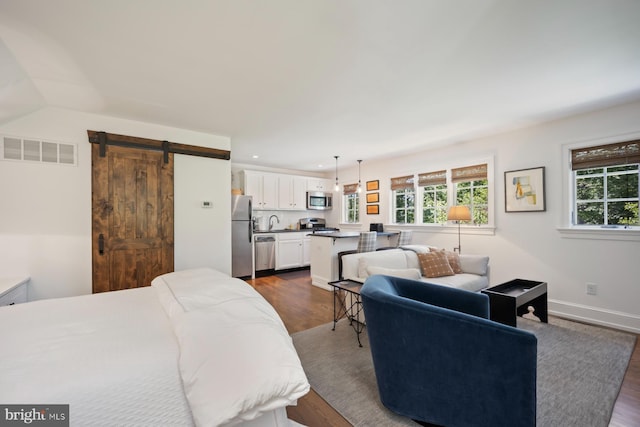 1660 Mount Pleasant Rd, Villanova, PA 19085 - bedroom with a sink, freestanding refrigerator, dark wood finished floors, visible vents, and a barn door