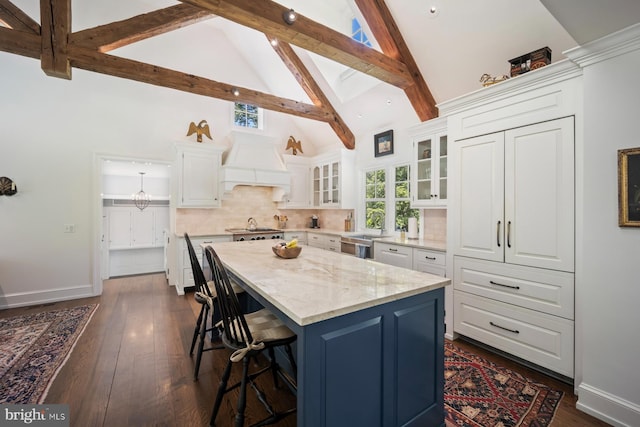 1660 Mount Pleasant Rd, Villanova, PA 19085 - kitchen with premium range hood, a breakfast bar, high vaulted ceiling, white cabinetry, and a kitchen island