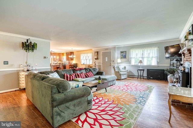 14957 Cherry Ln, Ridgely, MD 21660 - living room featuring hardwood / wood-style flooring, crown molding, a baseboard heating unit, a chandelier, and baseboards