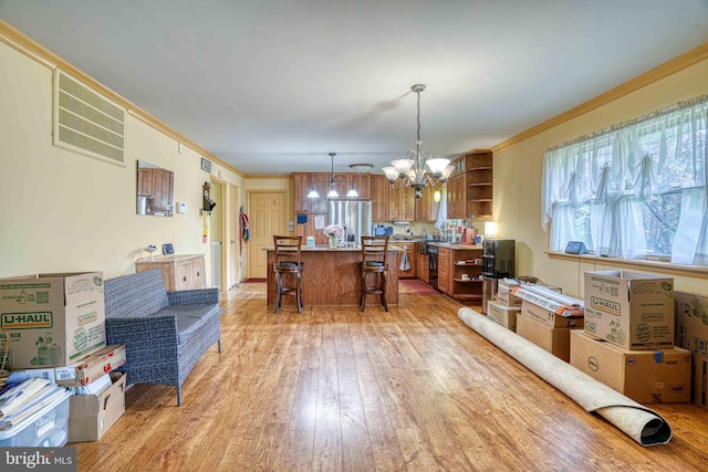 14957 Cherry Ln, Ridgely, MD 21660 - dining space featuring a chandelier, healthy amount of natural light, light wood-type flooring, and ornamental molding