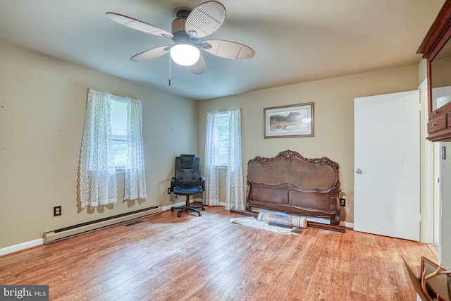 14957 Cherry Ln, Ridgely, MD 21660 - sitting room featuring baseboard heating, hardwood / wood-style floors, ceiling fan, and baseboards
