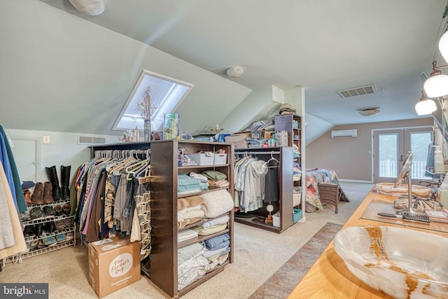 14957 Cherry Ln, Ridgely, MD 21660 - walk in closet featuring carpet floors, vaulted ceiling, a wall mounted air conditioner, french doors, and a skylight