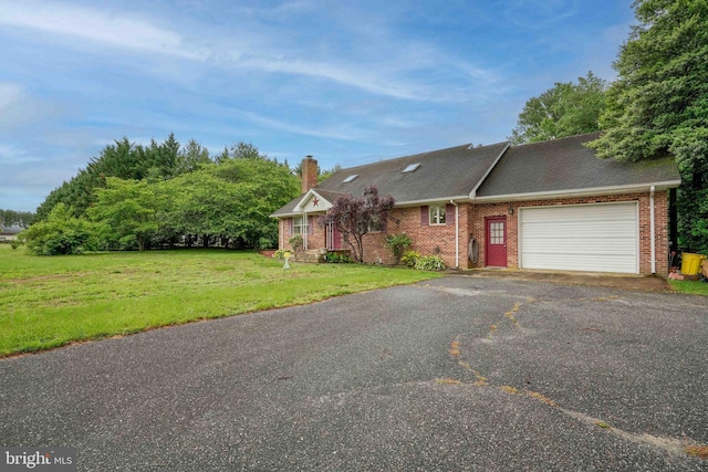 14957 Cherry Ln, Ridgely, MD 21660 - view of front facade featuring an attached garage, asphalt driveway, brick siding, a front lawn, and a chimney