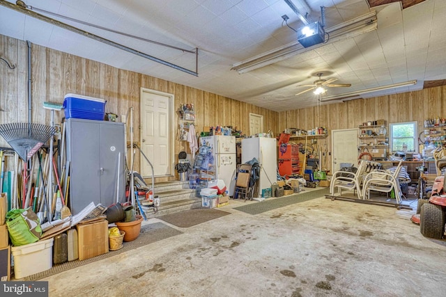 14957 Cherry Ln, Ridgely, MD 21660 - garage with wooden walls, a garage door opener, and a ceiling fan