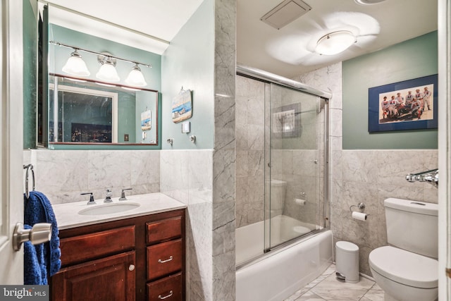 604 S Washington Sq Unit 1408, Philadelphia, PA 19106 - bathroom featuring tile walls, vanity, marble look tile flooring, toilet, and shower / bath combination with glass door
