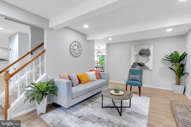 living room featuring stairway, baseboards, recessed lighting, and wood finished floors