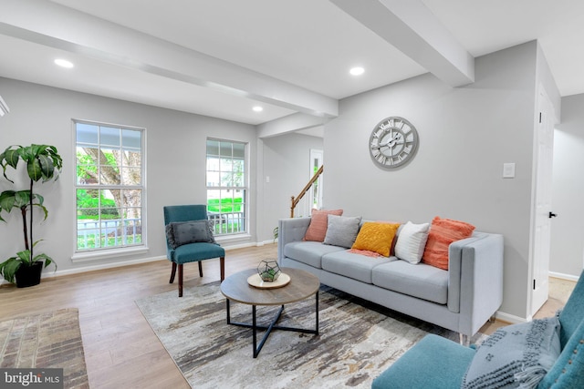 living room with baseboards, recessed lighting, light wood finished floors, and beam ceiling