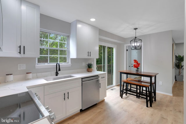 kitchen featuring an inviting chandelier, a sink, dishwasher, light wood-style flooring, and white cabinetry