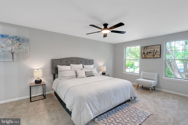 carpeted bedroom with baseboards and ceiling fan