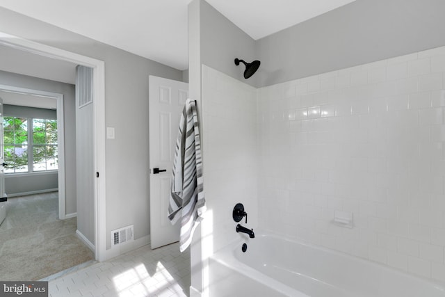 full bathroom featuring bathing tub / shower combination, baseboards, and visible vents