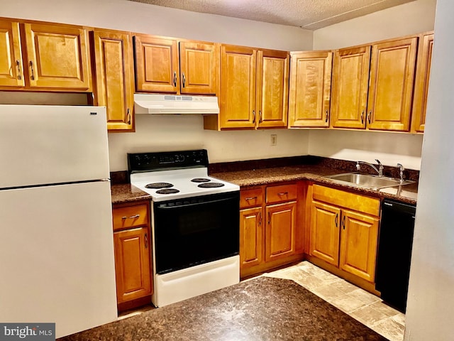 338 Saybrook Ln, Wallingford, PA 19086 - kitchen featuring freestanding refrigerator, under cabinet range hood, range with electric cooktop, a sink, and black dishwasher