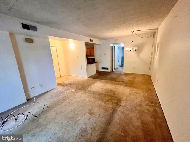 338 Saybrook Ln, Wallingford, PA 19086 - empty room featuring carpet flooring, a chandelier, and a textured ceiling