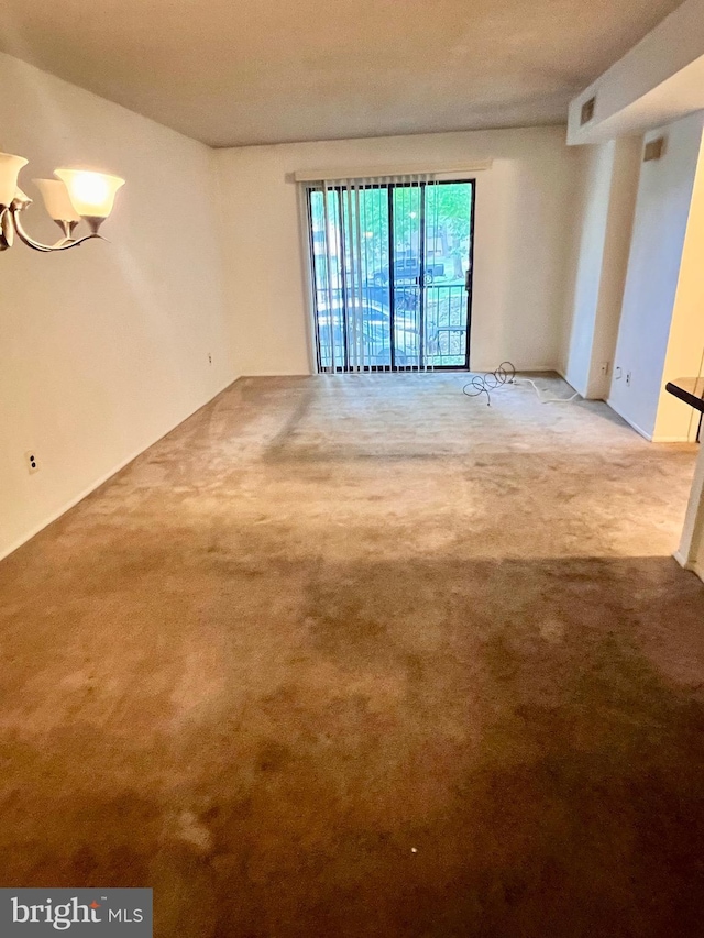 338 Saybrook Ln, Wallingford, PA 19086 - empty room featuring a chandelier and carpet flooring