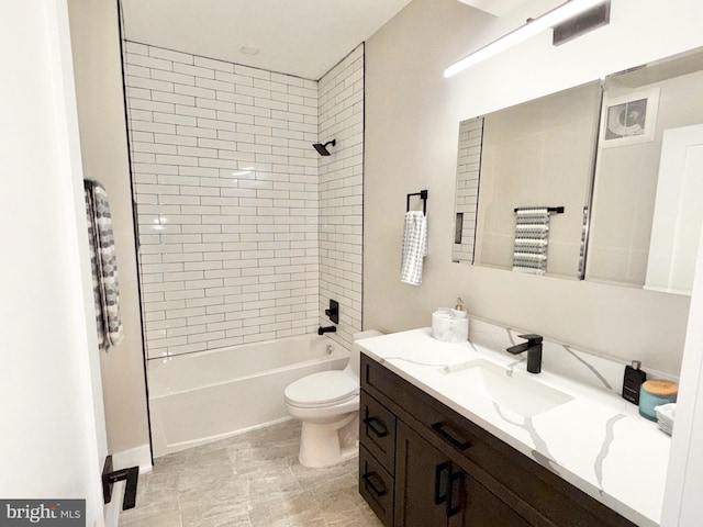bathroom with vanity, washtub / shower combination, and toilet