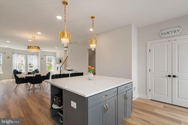 17303 Turnstone Dr, Dumfries, VA 22026 - kitchen with gray cabinetry, a chandelier, light wood-type flooring, open shelves, and pendant lighting