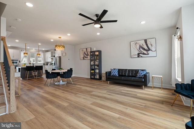 17303 Turnstone Dr, Dumfries, VA 22026 - living room with a ceiling fan, light wood-style floors, stairs, recessed lighting, and baseboards