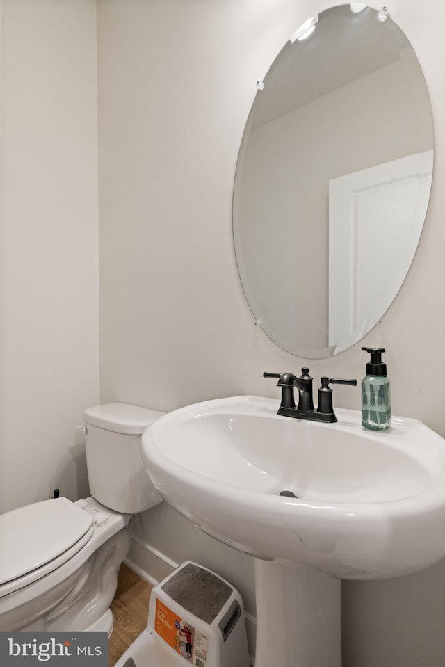 17303 Turnstone Dr, Dumfries, VA 22026 - bathroom with toilet, a sink, and wood finished floors