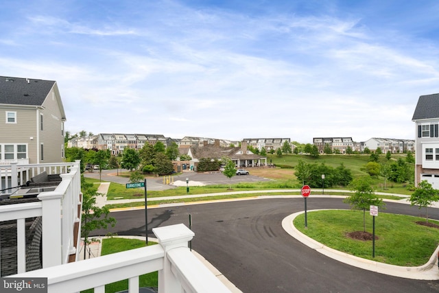 17303 Turnstone Dr, Dumfries, VA 22026 - view of asphalt street with traffic signs, curbs, sidewalks, and a residential view