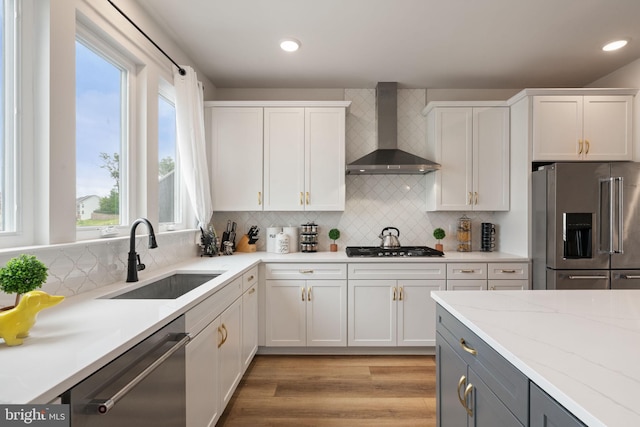 17303 Turnstone Dr, Dumfries, VA 22026 - kitchen featuring wall chimney exhaust hood, appliances with stainless steel finishes, a sink, plenty of natural light, and recessed lighting