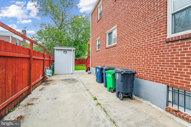 6023 20th Ave, Hyattsville, MD 20782 - view of home's exterior with a shed, a patio area, a fenced backyard, and brick siding