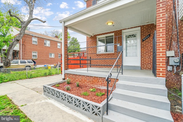 6023 20th Ave, Hyattsville, MD 20782 - doorway to property with fence, a porch, and brick siding