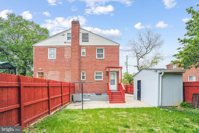 6023 20th Ave, Hyattsville, MD 20782 - back of house with a patio area, entry steps, a chimney, an outbuilding, and brick siding
