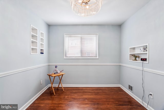 6023 20th Ave, Hyattsville, MD 20782 - unfurnished room with wood finished floors, a chandelier, built in shelves, and baseboards
