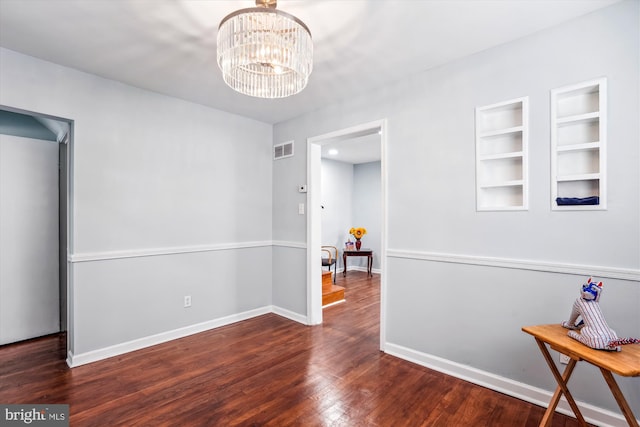 6023 20th Ave, Hyattsville, MD 20782 - spare room with wood finished floors, built in features, a chandelier, and baseboards