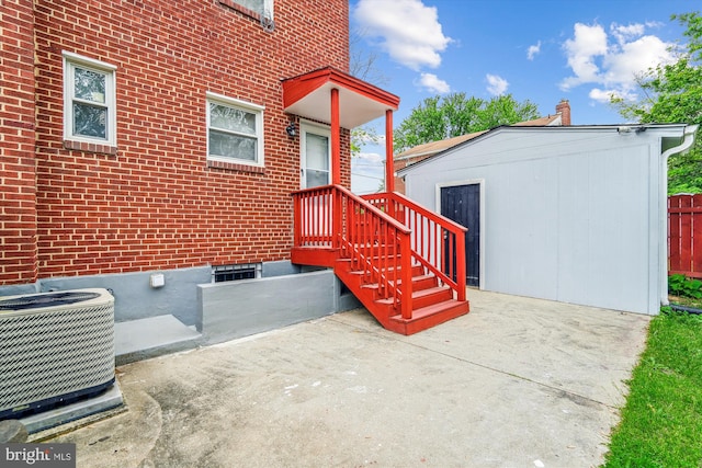 6023 20th Ave, Hyattsville, MD 20782 - doorway to property with cooling unit, brick siding, and a patio area