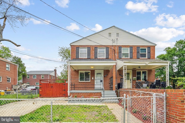6023 20th Ave, Hyattsville, MD 20782 - view of front of home with a porch, a gate, brick siding, and a fenced front yard