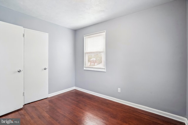 6023 20th Ave, Hyattsville, MD 20782 - unfurnished bedroom with dark wood-style flooring and baseboards