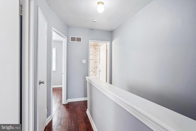 6023 20th Ave, Hyattsville, MD 20782 - hallway with baseboards, dark wood-type flooring, and an upstairs landing