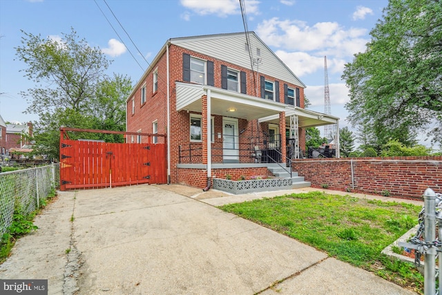 6023 20th Ave, Hyattsville, MD 20782 - view of front of home featuring brick siding, covered porch, fence, and a gate