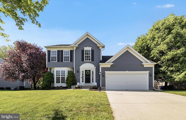 view of front of house with a garage, a front lawn, and driveway