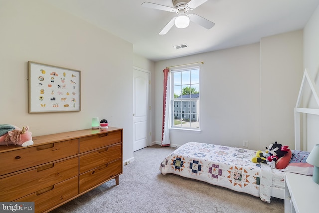 bedroom featuring light carpet, baseboards, a ceiling fan, and visible vents