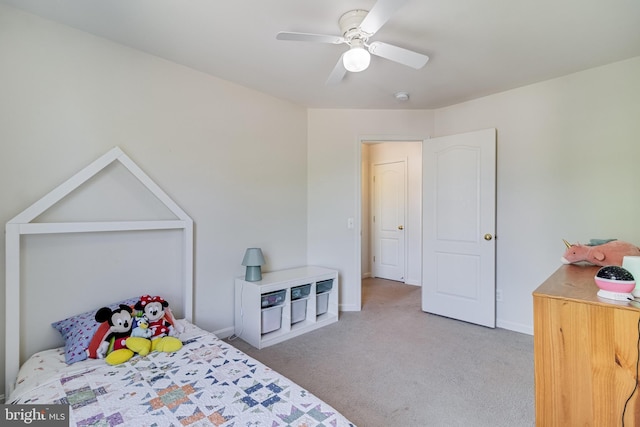 carpeted bedroom featuring baseboards and a ceiling fan