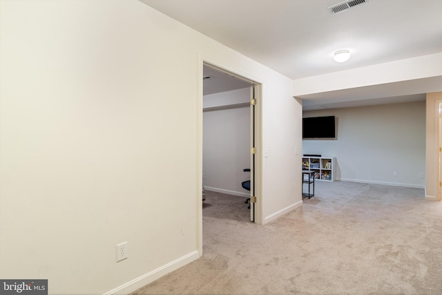 corridor with baseboards, visible vents, and carpet floors