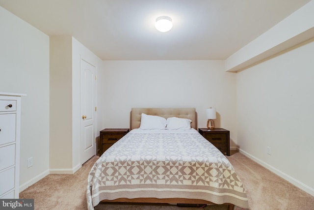 bedroom featuring baseboards and light carpet