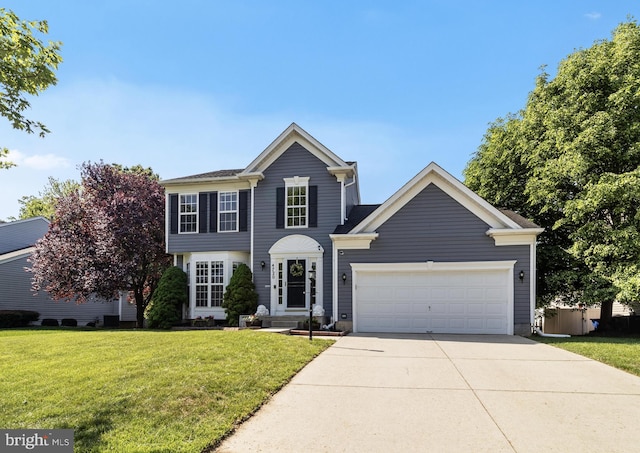 colonial-style house with a front yard, a garage, and driveway