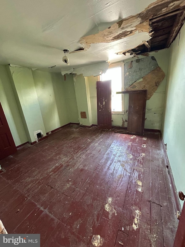interior space with baseboards and wood-type flooring