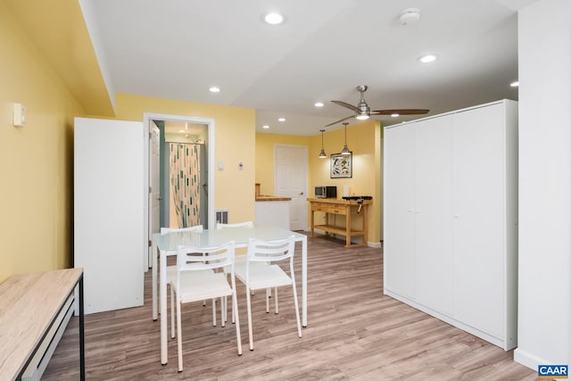 dining space featuring light wood-style floors, a ceiling fan, baseboard heating, and recessed lighting