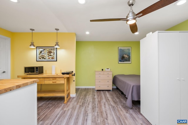 bedroom featuring light wood-type flooring, recessed lighting, and baseboards