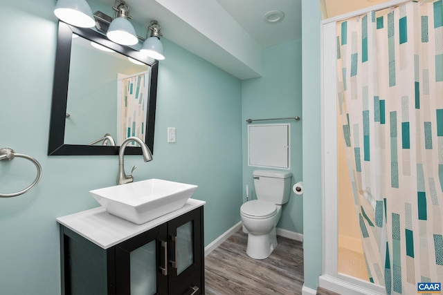 full bathroom featuring vanity, wood finished floors, curtained shower, toilet, and baseboards