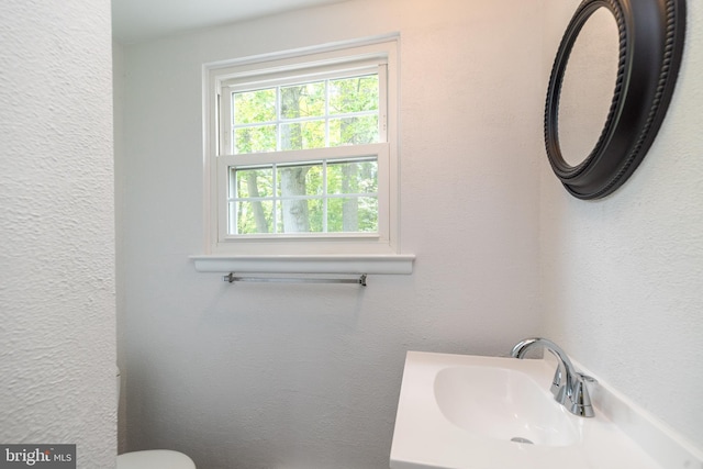 half bathroom featuring a sink