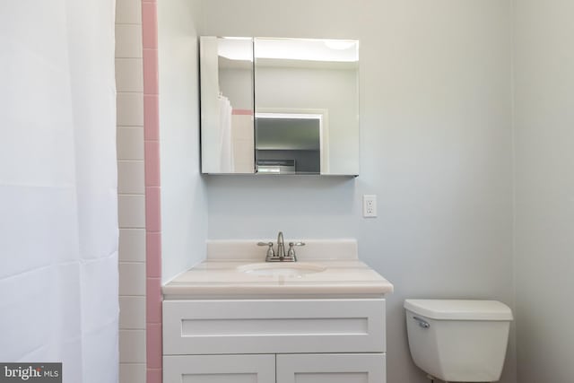 full bathroom featuring vanity and toilet